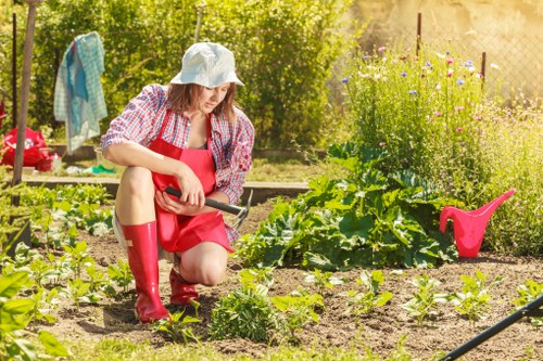 Trained gardener using protective equipment on site