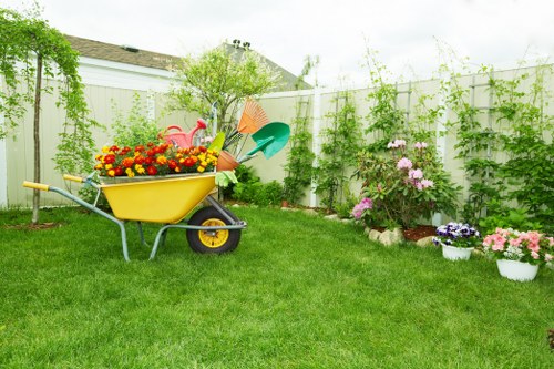 Rear garden transformation with planting beds and paved seating area in Merton